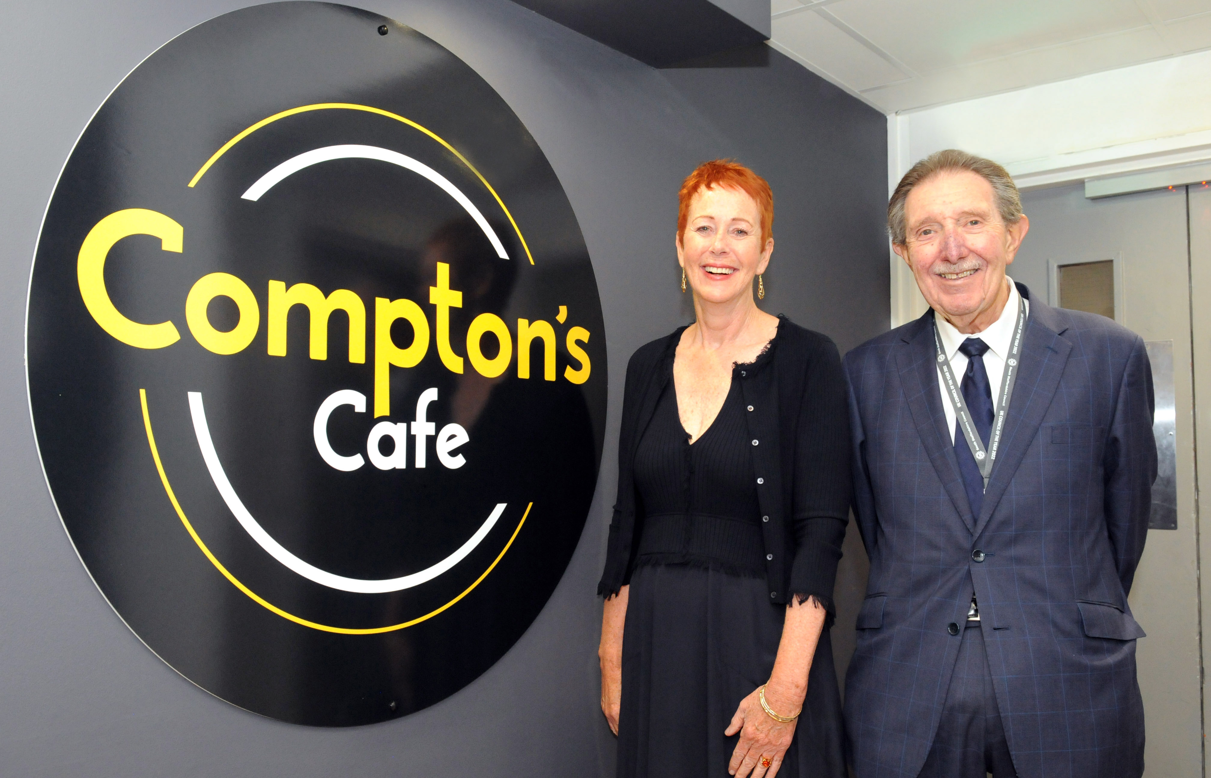 Cllr Roger Lees and Chairman of the Board Ros Keeton with the Compton's Cafe logo