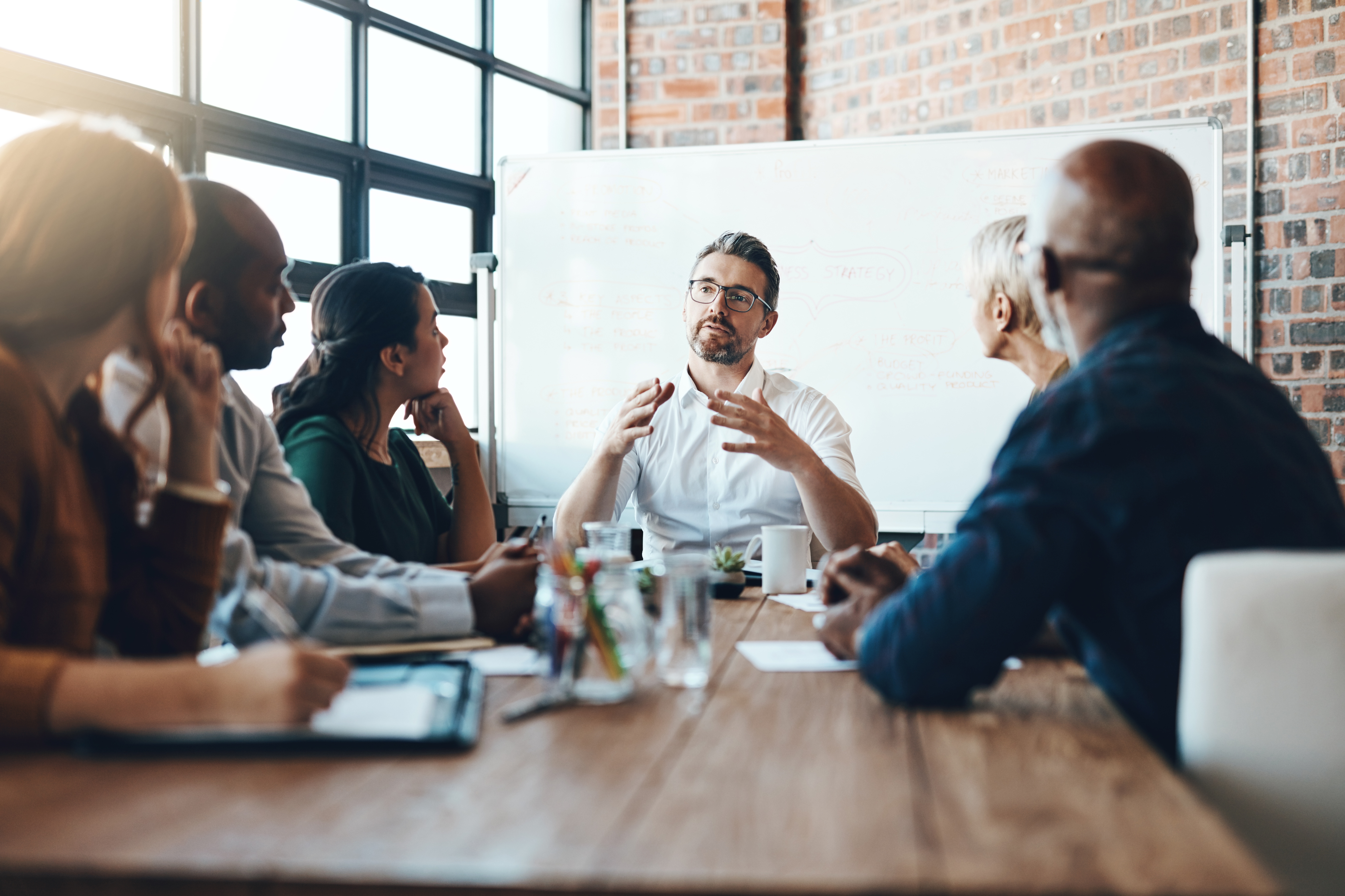 Stock image of business people sat in a board room meeting
