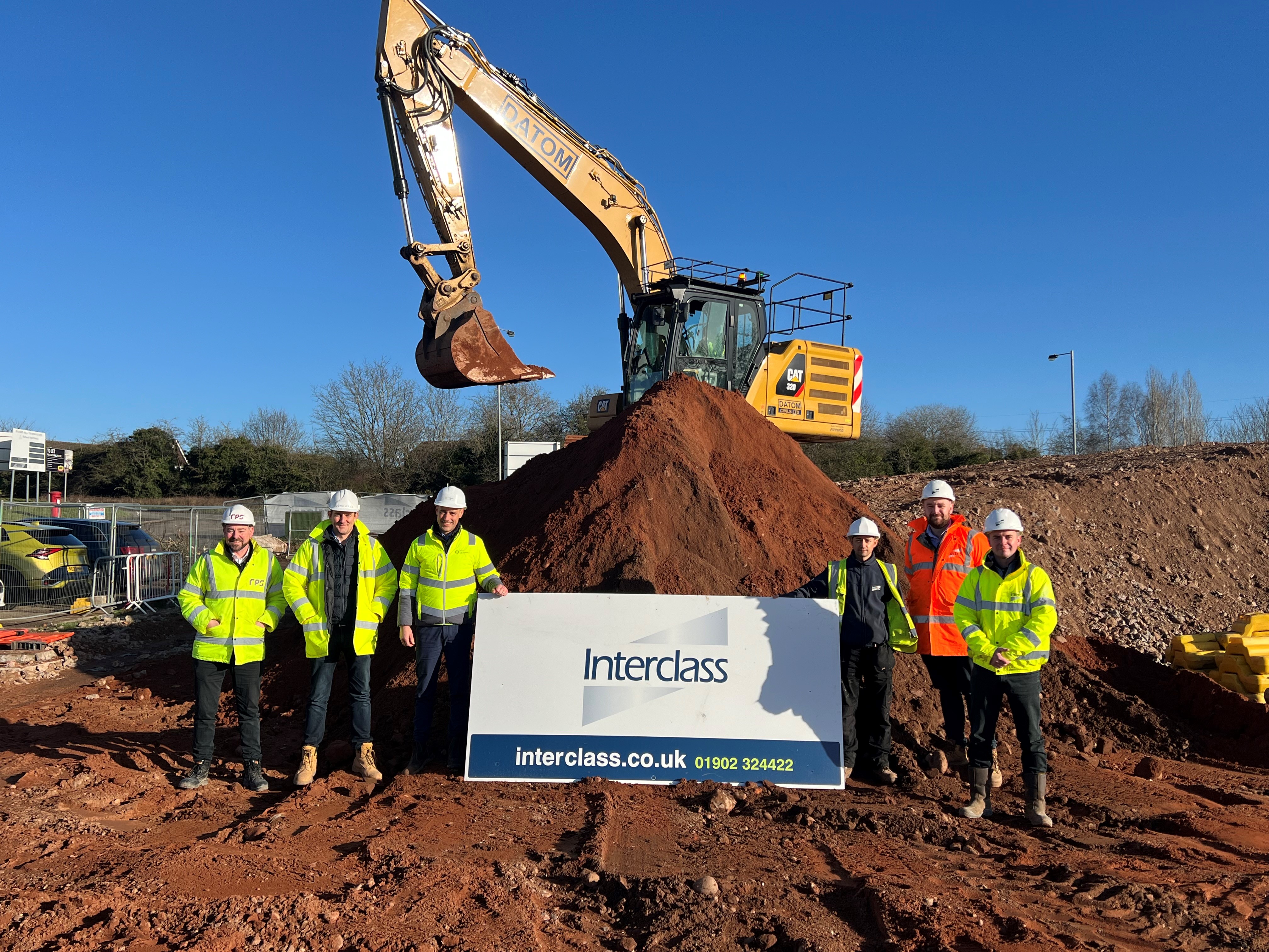 Imre Tolgyesi, assistant director for commercial, assets and estates - pictured third from left - with the team from Interclass on a building site