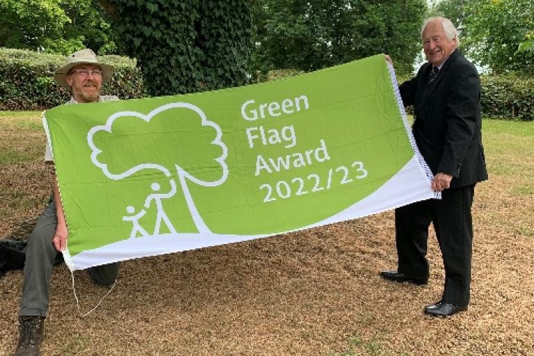 two people proudly displaying the green flag