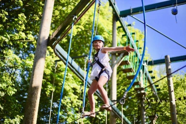 child balancing on a high rope