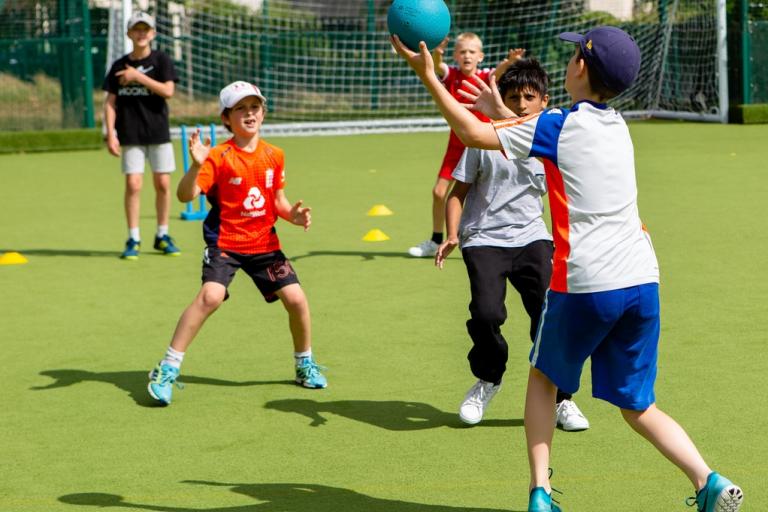 Image shows boys playing football outside