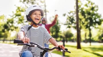 Boy rides on bike in safe neighbourhood
