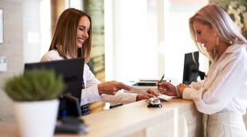 A customer services team member greets a visitor