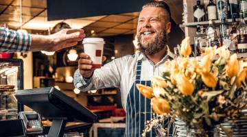 Barista serves a customer