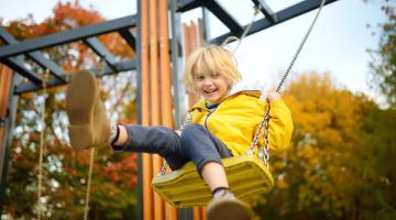 Child plays on a swing