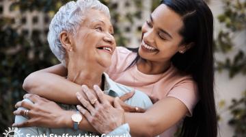 Two ladies hugging and smiling
