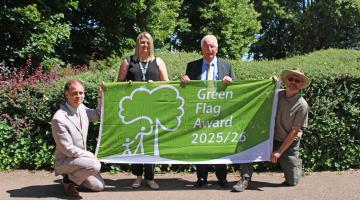 Pictured left to right: South Staffordshire Council officers Ryan Taylor and Bec Morgan with cabinet member for community services Councillor Mike Davies and officer Steve Gallis. They stand outside holding a Green Flag. 