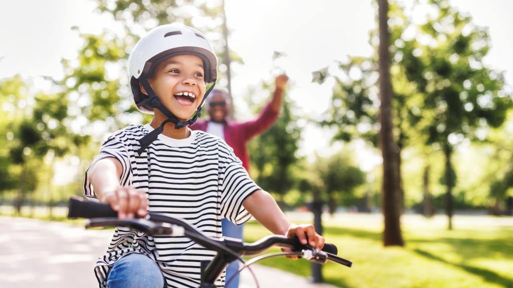 Boy rides on bike in safe neighbourhood