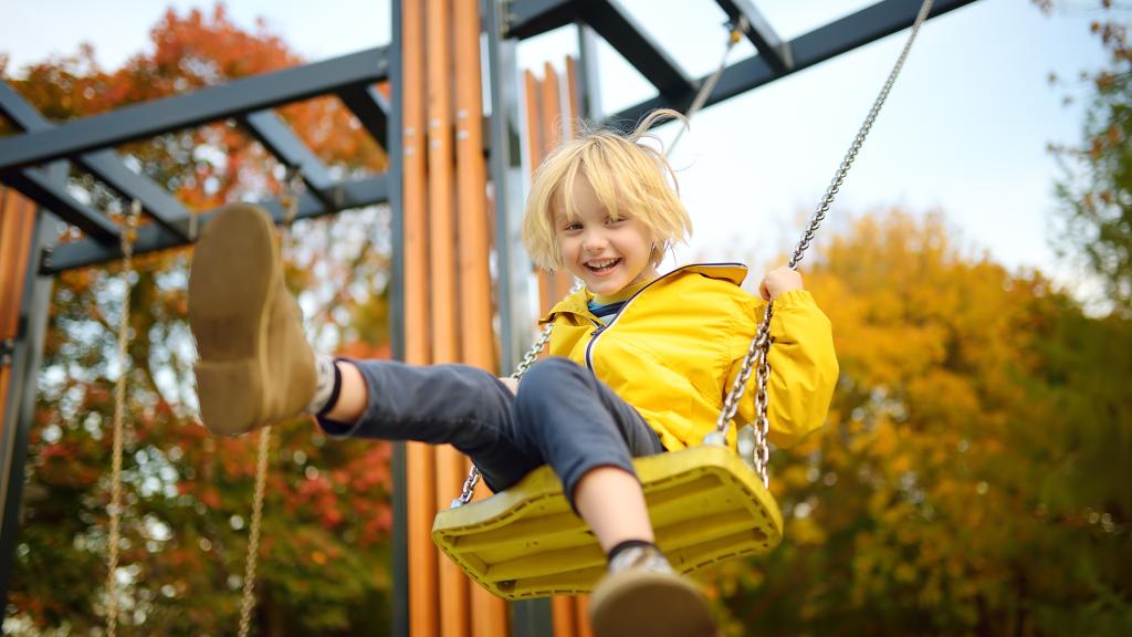 Child plays on a swing