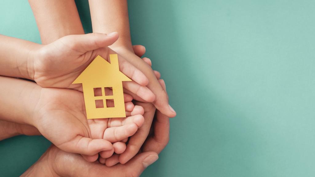 image of hands holding a house