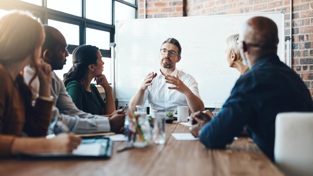 Stock image of business people sat in a board room meeting