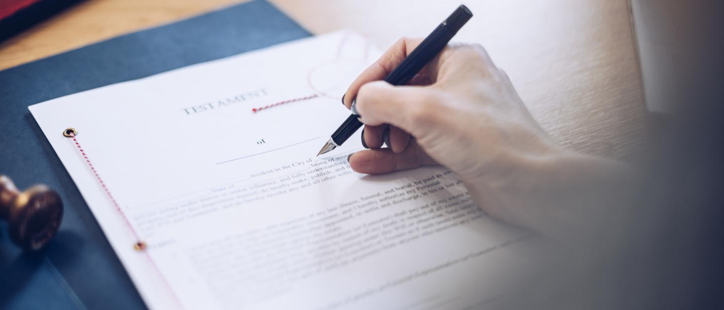A person signs a last will and testament