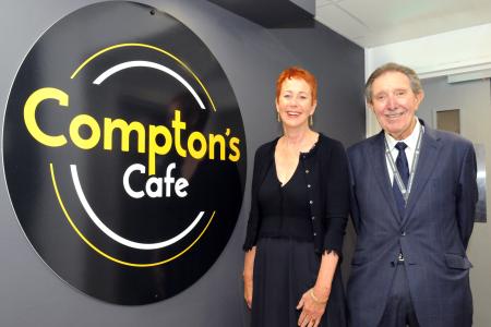 Cllr Roger Lees and Chairman of the Board Ros Keeton with the Compton's Cafe logo