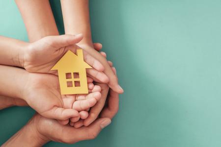 image of hands holding a house