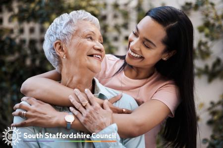 Two ladies hugging and smiling