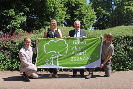 Pictured left to right: South Staffordshire Council officers Ryan Taylor and Bec Morgan with cabinet member for community services Councillor Mike Davies and officer Steve Gallis. They stand outside holding a Green Flag.