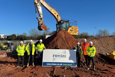 Imre Tolgyesi, assistant director for commercial, assets and estates - pictured third from left - with the team from Interclass on a building site